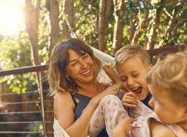 Mother with two children in a hammock outside