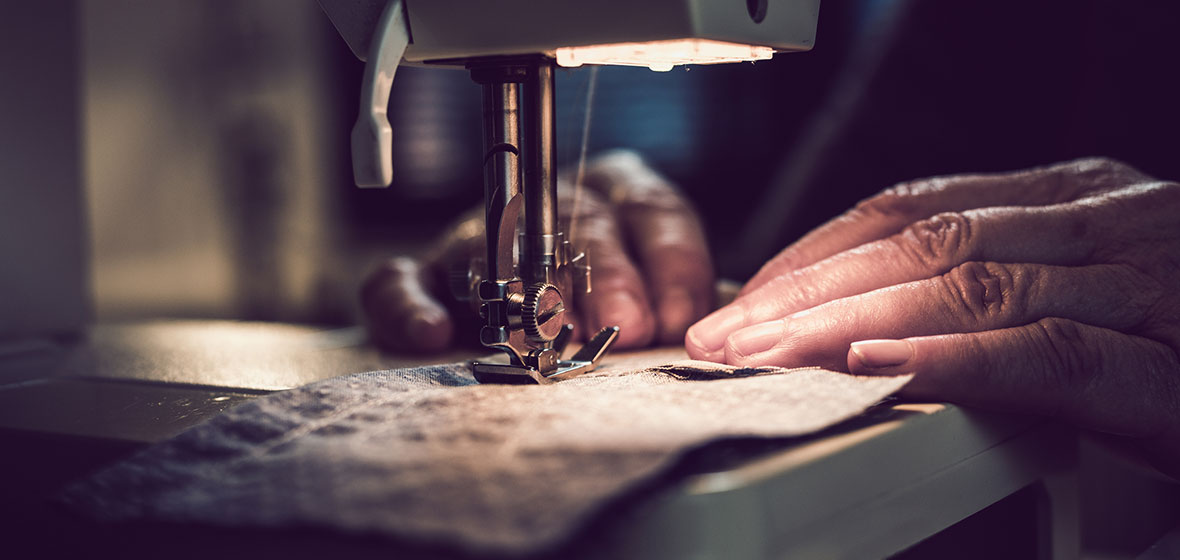 Vulnerable worker uses a sewing machine