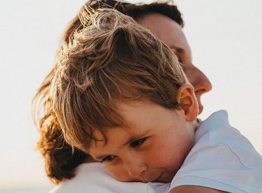 Mother hugs her son