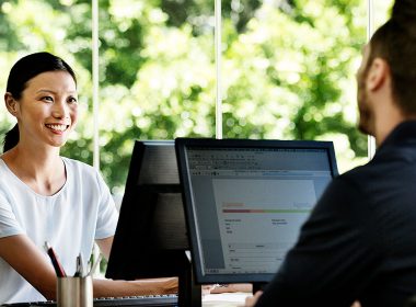 Man and woman using computers in an office