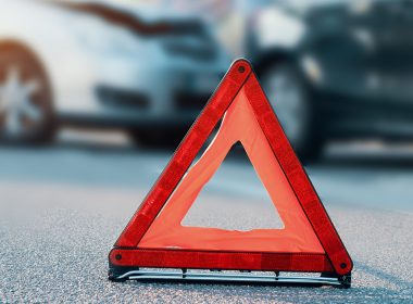 Traffic cone in front of two cars after an accident