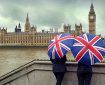 Tourists looking at Big Ben across the river.