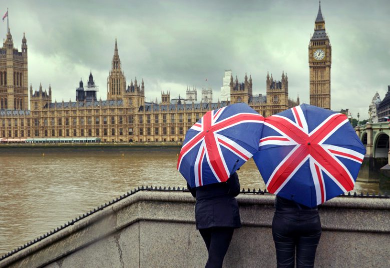 Tourists looking at Big Ben across the river.