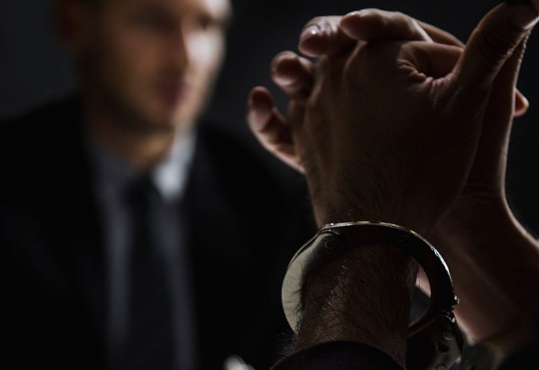 Cuffed prisoner gives testimony