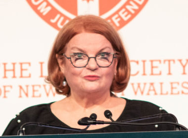 President of the Law Society of NSW Juliana Warner speaking in front of a lectern.