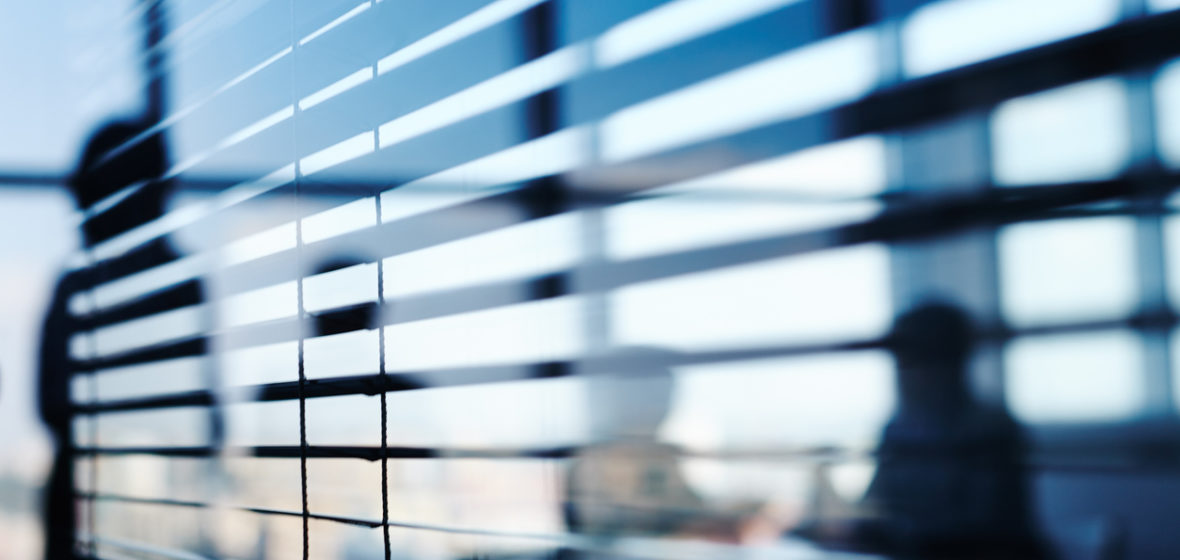 people behind blinds in an office