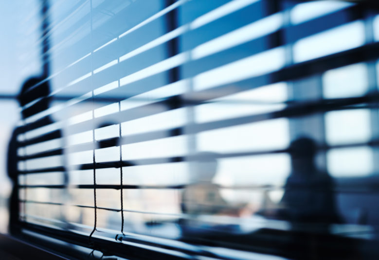 people behind blinds in an office