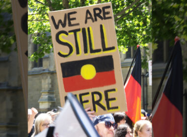 crowd holding poster calling for Indigenous constitutional recognition