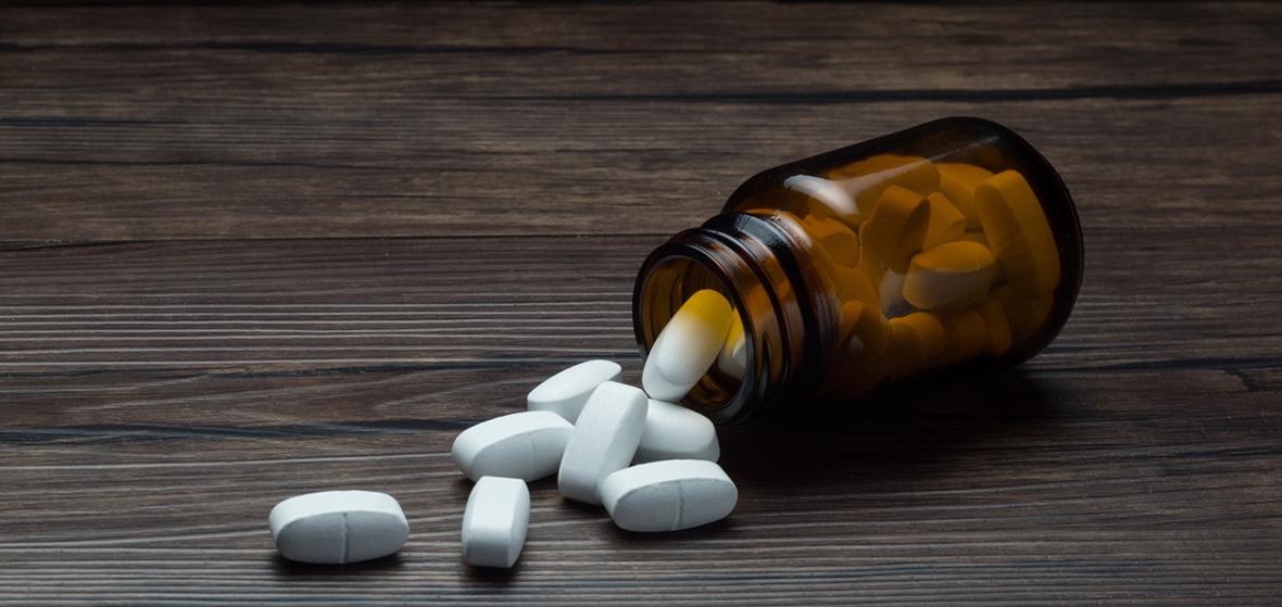 medicine bottle with pills spilling out