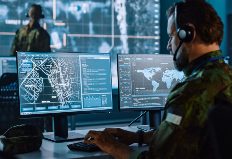 photo showing man in military camouflage doing data surveillance
