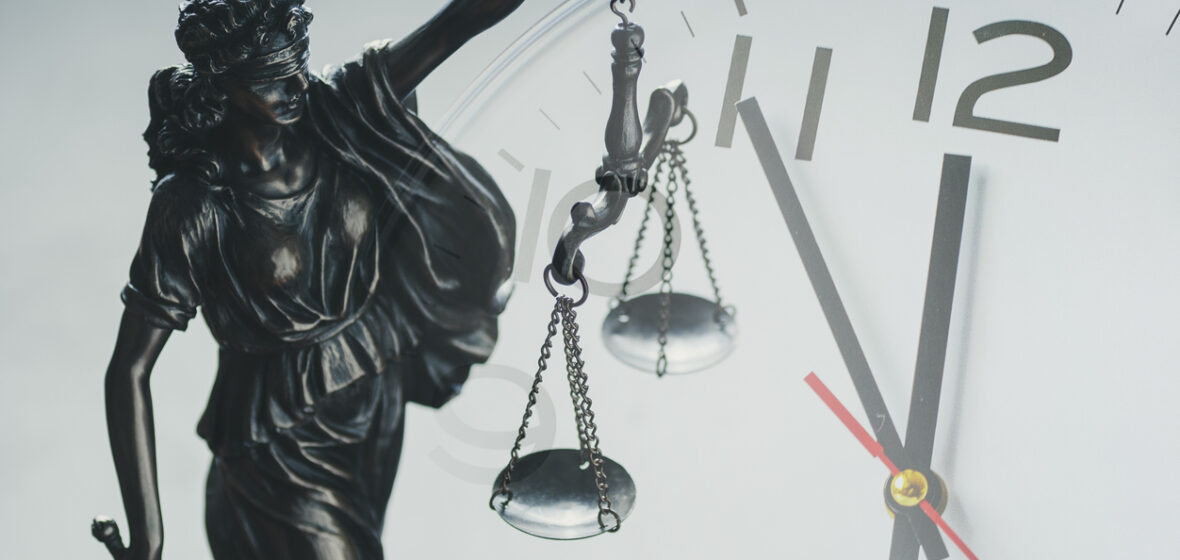photo of sclaes of justice and clock to illustrate delays in coronial system