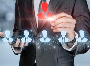 pciture of man in suit with images of heads connected to networks to show ai recruitment