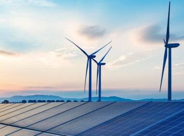 picture showing wind turbines and solar energy roofs to depict renewable energy landscape