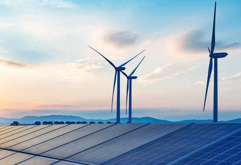 picture showing wind turbines and solar energy roofs to depict renewable energy landscape