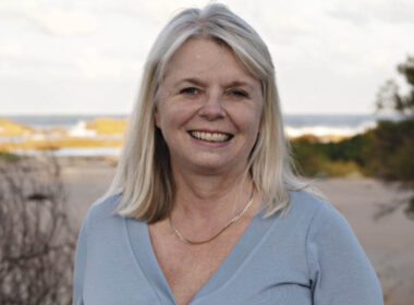 photo of lawyer Anita Cains with the sea in the bakcground