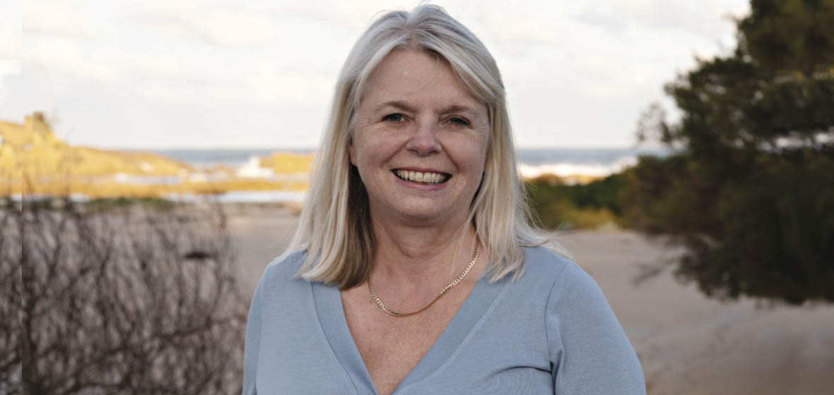 photo of lawyer Anita Cains with the sea in the bakcground