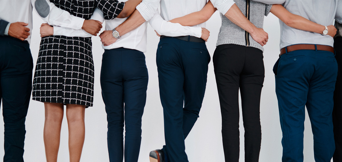 photo of people in business clothes with their arms around each other to illustrate being a mental health ally at work