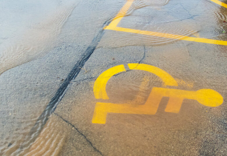 photo showing disability parking sign under floodwater