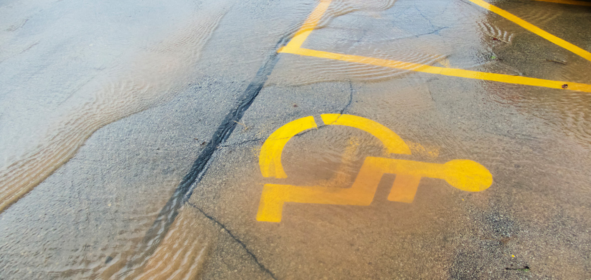 photo showing disability parking sign under floodwater